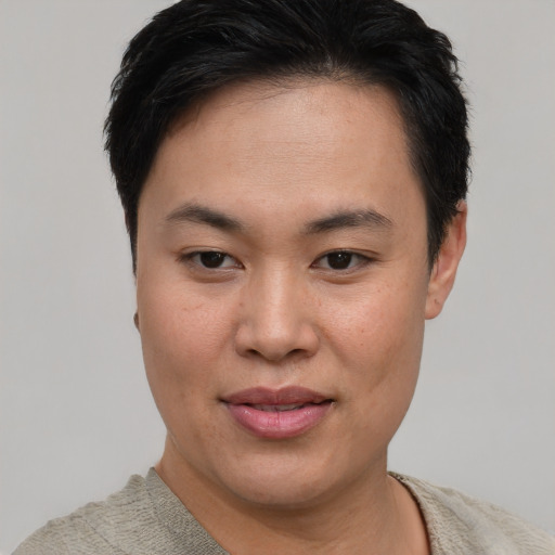 Joyful asian young-adult female with short  brown hair and brown eyes