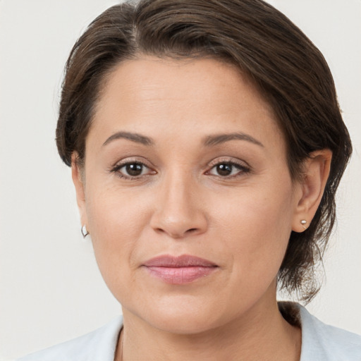 Joyful white young-adult female with medium  brown hair and brown eyes