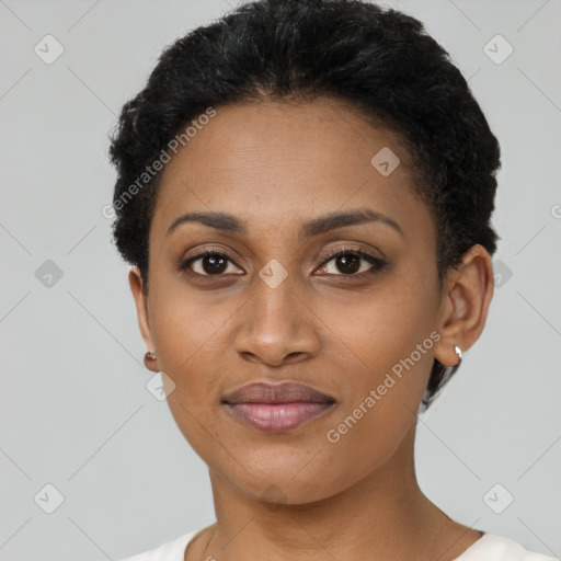 Joyful black young-adult female with short  black hair and brown eyes