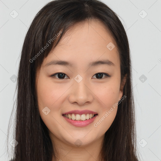 Joyful asian young-adult female with long  brown hair and brown eyes