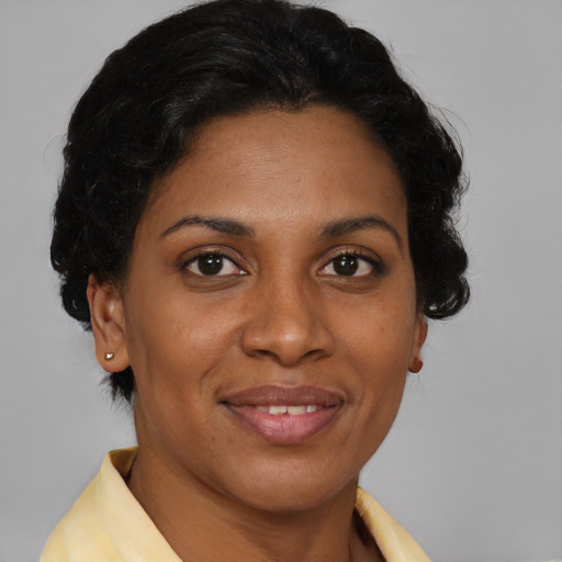 Joyful latino adult female with short  brown hair and brown eyes