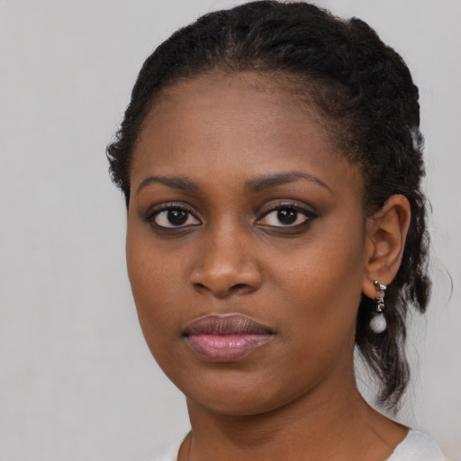 Joyful black young-adult female with medium  brown hair and brown eyes