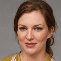 Joyful white young-adult female with medium  brown hair and brown eyes