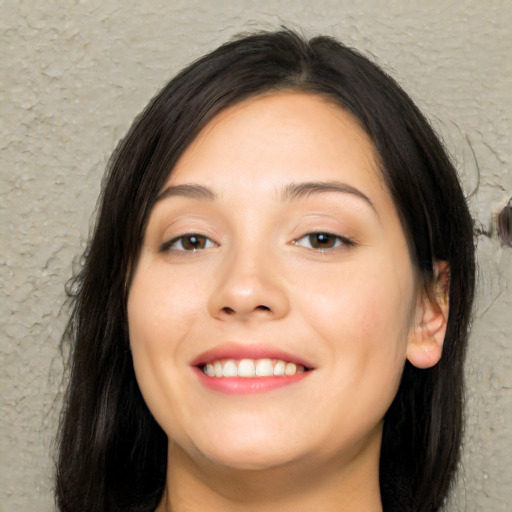 Joyful asian young-adult female with long  brown hair and brown eyes