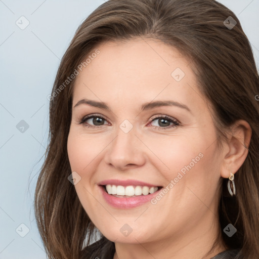 Joyful white young-adult female with long  brown hair and brown eyes