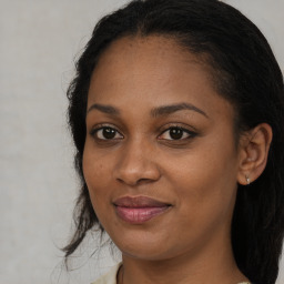 Joyful black young-adult female with long  brown hair and brown eyes