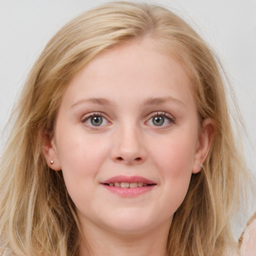 Joyful white young-adult female with long  brown hair and blue eyes