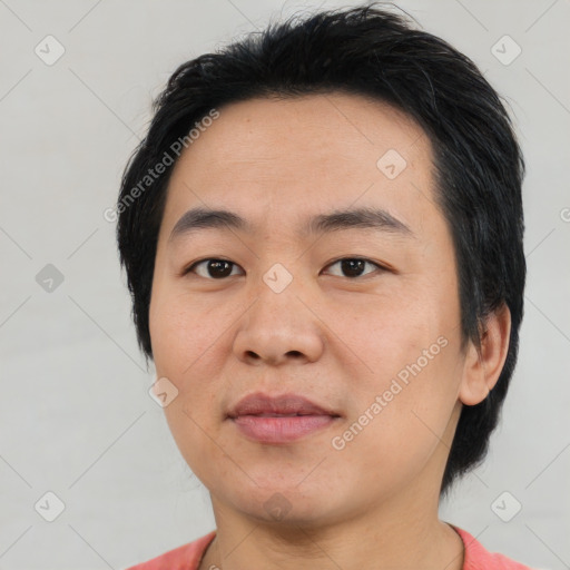 Joyful asian young-adult male with short  black hair and brown eyes