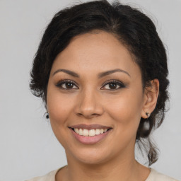 Joyful latino young-adult female with long  brown hair and brown eyes