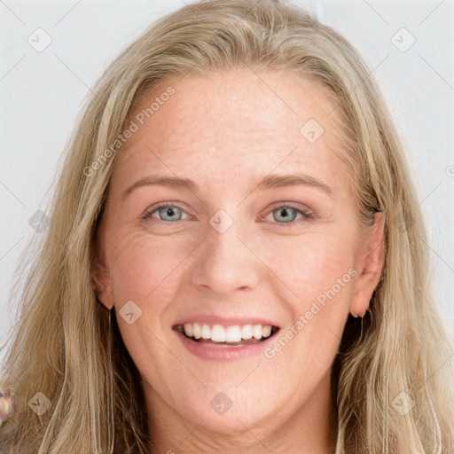 Joyful white young-adult female with long  brown hair and blue eyes