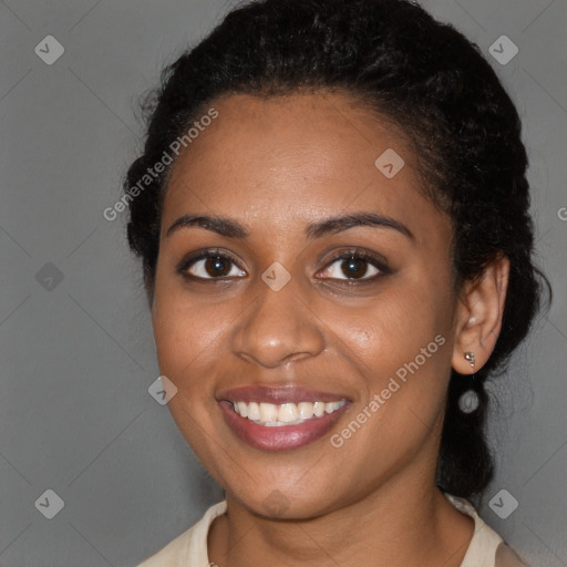 Joyful black young-adult female with long  brown hair and brown eyes