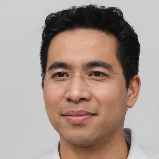 Joyful asian adult male with short  black hair and brown eyes