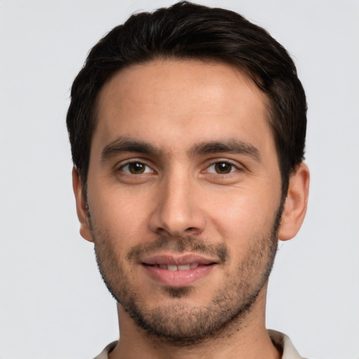 Joyful white young-adult male with short  black hair and brown eyes