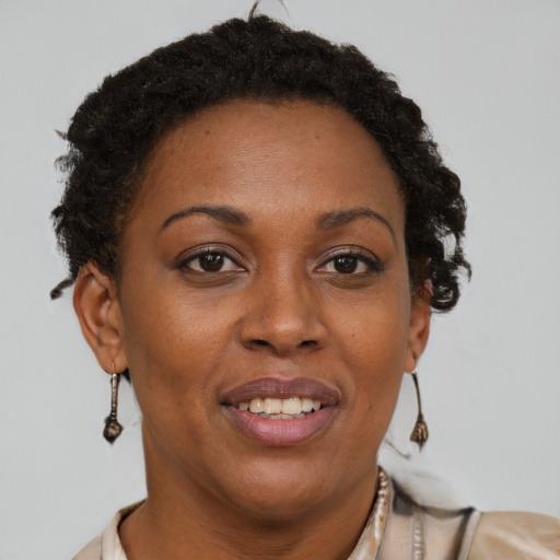 Joyful black adult female with short  brown hair and brown eyes