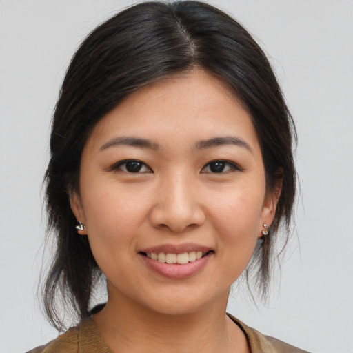 Joyful asian young-adult female with medium  brown hair and brown eyes