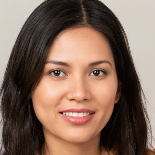 Joyful white young-adult female with long  brown hair and brown eyes