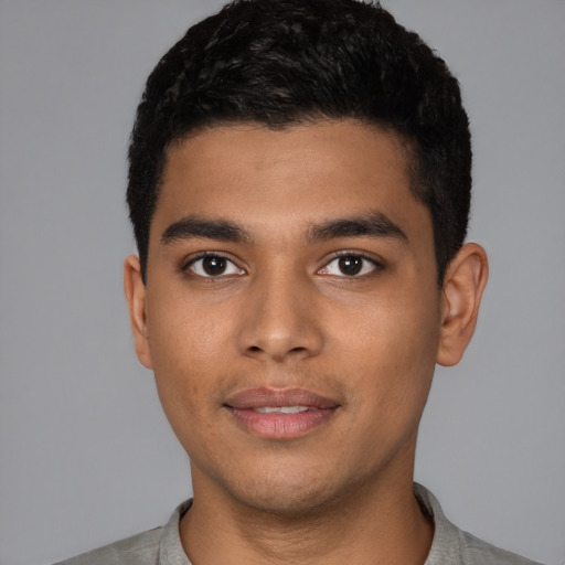 Joyful latino young-adult male with short  black hair and brown eyes