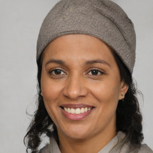 Joyful white adult female with medium  black hair and brown eyes