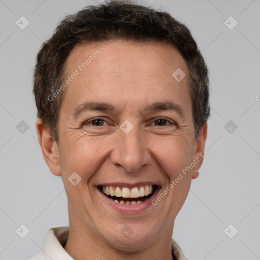 Joyful white adult male with short  brown hair and brown eyes