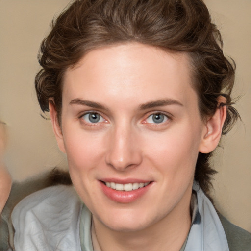 Joyful white young-adult female with medium  brown hair and blue eyes