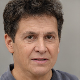 Joyful white middle-aged male with short  brown hair and brown eyes