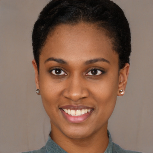 Joyful black young-adult female with short  brown hair and brown eyes