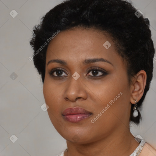 Joyful black young-adult female with short  black hair and brown eyes