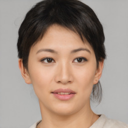 Joyful asian young-adult female with short  brown hair and brown eyes