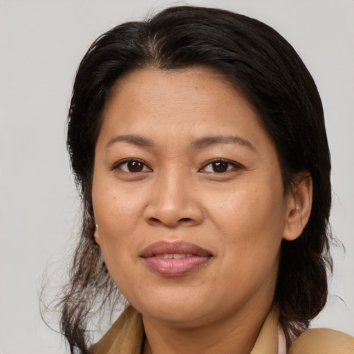 Joyful asian adult female with medium  brown hair and brown eyes