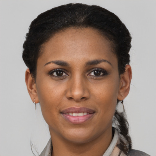 Joyful black young-adult female with short  brown hair and brown eyes