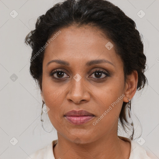 Joyful black adult female with medium  brown hair and brown eyes