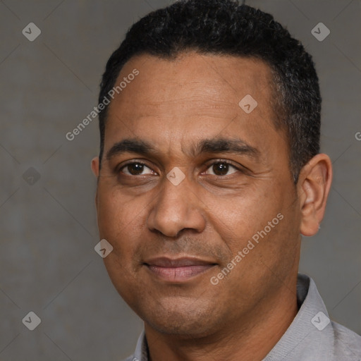 Joyful black adult male with short  black hair and brown eyes