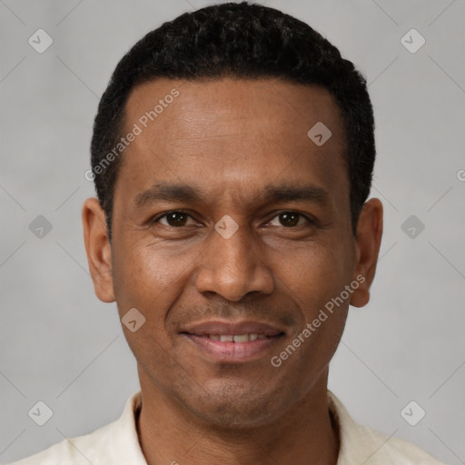 Joyful latino young-adult male with short  brown hair and brown eyes