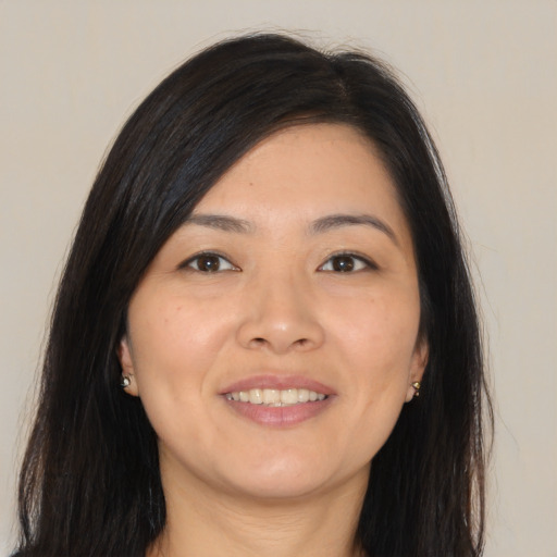 Joyful asian young-adult female with long  black hair and brown eyes