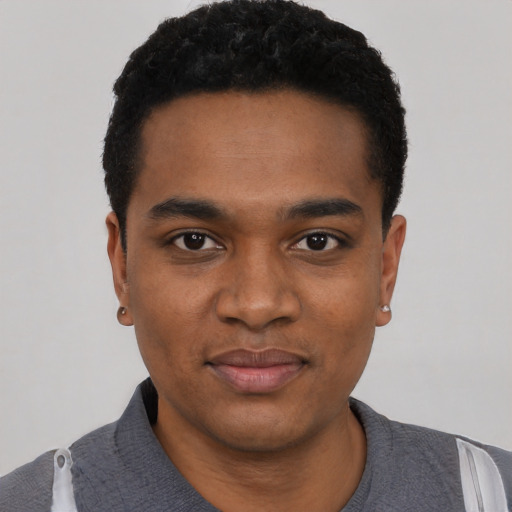 Joyful black young-adult male with short  black hair and brown eyes