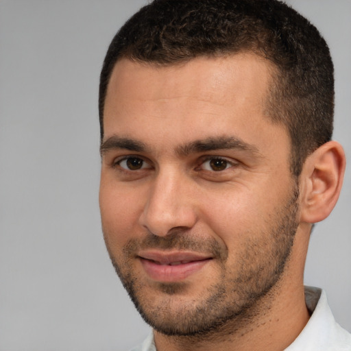 Joyful white young-adult male with short  brown hair and brown eyes