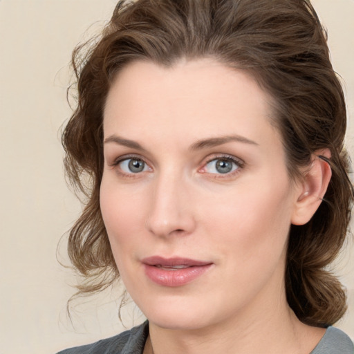 Joyful white young-adult female with medium  brown hair and green eyes