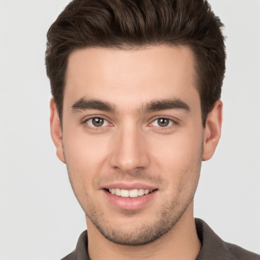 Joyful white young-adult male with short  brown hair and brown eyes