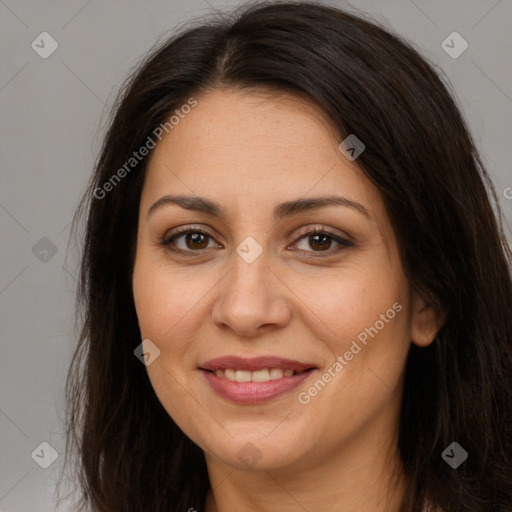 Joyful white adult female with long  brown hair and brown eyes