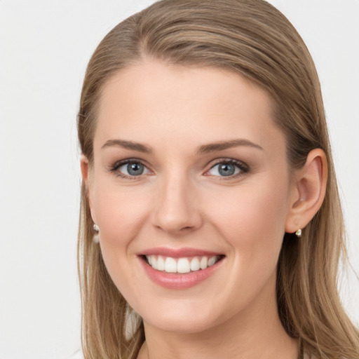 Joyful white young-adult female with long  brown hair and blue eyes