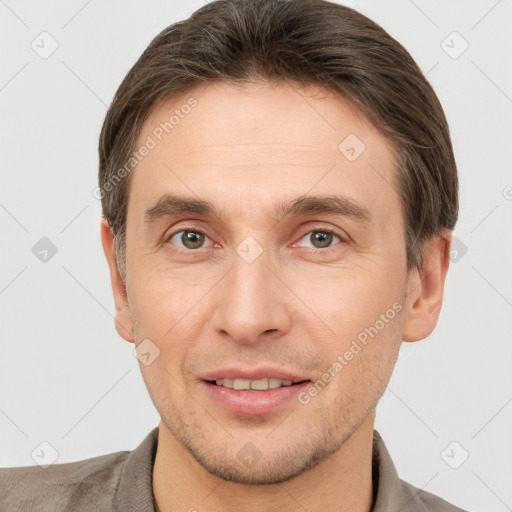 Joyful white adult male with short  brown hair and brown eyes