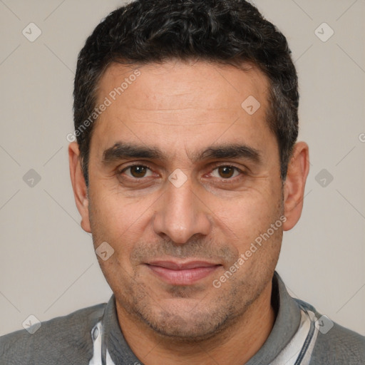 Joyful white adult male with short  black hair and brown eyes