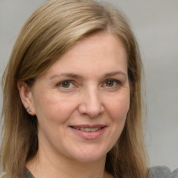 Joyful white adult female with medium  brown hair and grey eyes