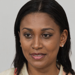 Joyful black adult female with medium  brown hair and brown eyes