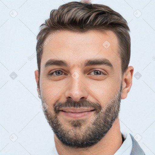 Joyful white young-adult male with short  black hair and brown eyes