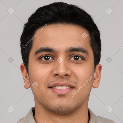 Joyful latino young-adult male with short  black hair and brown eyes