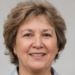 Joyful white middle-aged female with medium  brown hair and brown eyes