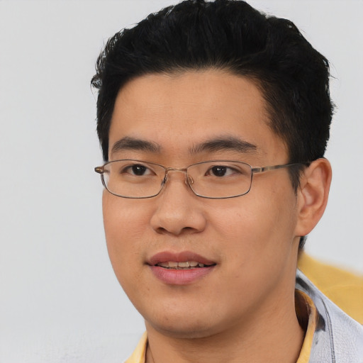 Joyful asian young-adult male with short  black hair and brown eyes
