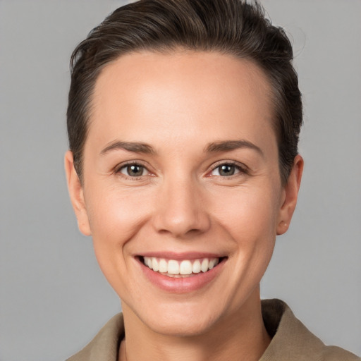 Joyful white young-adult female with short  brown hair and brown eyes