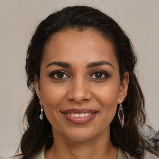 Joyful latino young-adult female with medium  brown hair and brown eyes